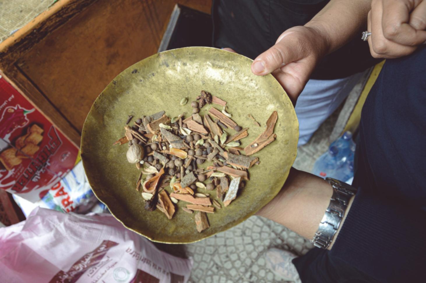 Fresh vegetables and herbs arranged on a rustic wooden cutting board, showcasing the colorful ingredients used in plant-based cooking